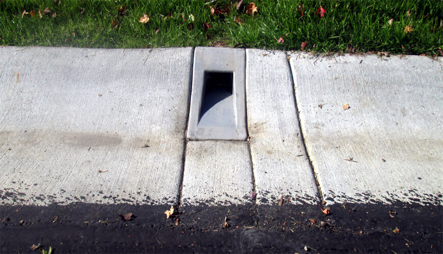 downspout through sidewalk