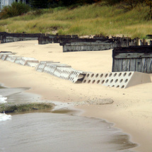 Sand being built up on both sides of Sandsaver modules on Lake Michigan