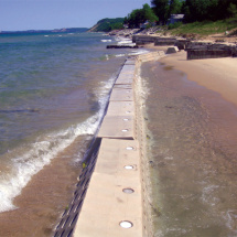 Waves crashing against Sandsaver modules Lake Michigan.