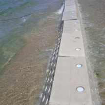 Wave energy breaking down against the Sandsaver modules